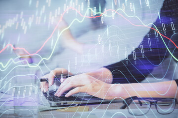 Multi exposure of woman hands typing on computer and financial graph hologram drawing. Stock market analysis concept.