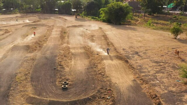 Aerial view of Motorcycle racers train on the motocross track, among the sand hills. Cagayan de Oro, Mindanao, Philippines.