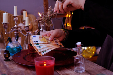 seance in salon of soothsayer, Librate with money, female hands of psychic doing witchcraft passes...