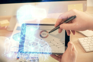 Double exposure of man's hands holding and using a digital device and AR glasses drawing. Virtual reality concept.