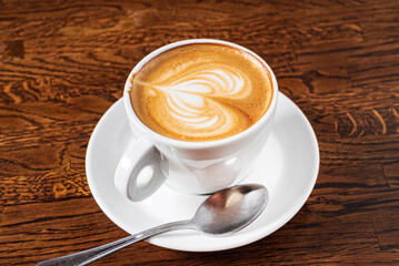 cup of cappuccino on the wooden table