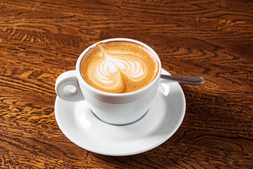 cup of cappuccino on the wooden table