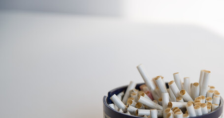 Large ashtray full of white cigarette butts
