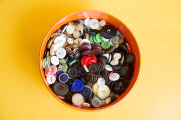 Multi-colored buttons in a box in a variety of sizes from small to very large