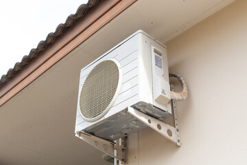 Side Big air conditioner compressor source heat pumps on wall outdoor on side house of building for cooling at industrial plant. For cooling in home or office and various places hot weather.