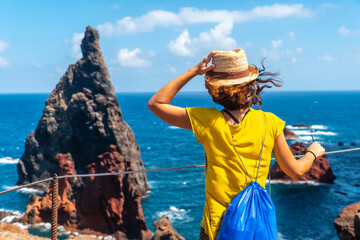 A young woman in the viewpoint looking at the rock formations at Ponta de Sao Lourenco, Madeira © unai