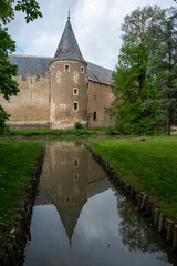 Castle of Ainay-le-Vieil reflected in her moat