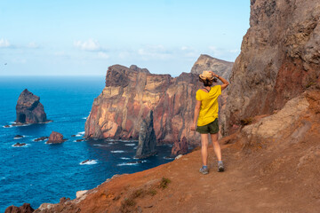 A young woman in Ponta de Sao Lourenco in summer looking at the landscape, Madeira