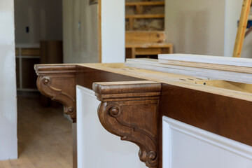 In a new kitchen, corbels were installed on the island to provide support for granite countertops on the island. © ungvar