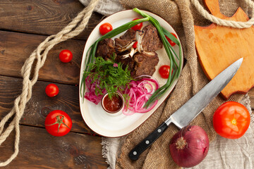 Rack of lamb in a plate on a wooden table.