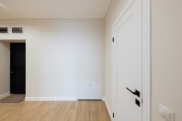 Interior design of a bright corridor with stylish furniture. Cleanliness and order