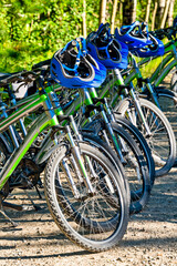 Fototapeta na wymiar Rental bikes and helmets ready for adventure tour