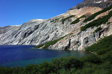 Patagonia nature Alpine lake blue water, Laguna Azul in Nahuel Huapi National Park, Surrounded by granite walls Cerro de las Cristales mountain, Man swimming far on distance, Argentina South America