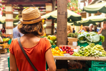 A tourist wearing a hat at the Farmers Market in the Madeira city of Funchal. Portugal