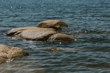Fototapeta premium A close-up of large stones in the water.