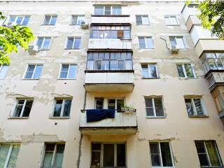 facade of shabby apartment house in Yoshkar-Ola city in summer day