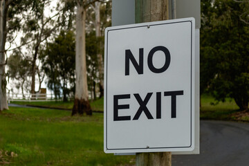 Road sign No Exit plate black on white in the park in Australia