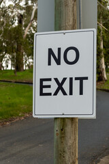 Road sign No Exit plate black on white in the park in Australia