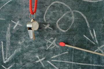 Whistle of soccer coach or referee and soccer tactics scribble on black board. Great soccer event...