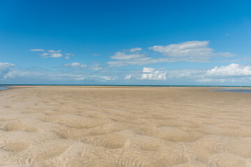 Fototapeta na wymiar Low tide seabed ocean floor bottom exposed beautiful textured sand dunes. Nature background. Theodolite creek at Woodgate beach, QLD, Australia