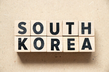 Alphabet letter block in word south korea on wood background