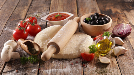 raw dough pizza and ingredients