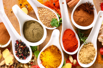 seasonings spices in spoon- Spice background top view