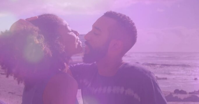 Animation of light spots over african american couple at beach