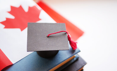 Canadian education system. Graduation cap on stack of books. Back to school. University degree