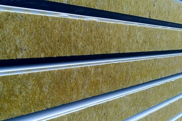 Sandwich panels with mineral wool filling, side view, a stack of panels prepared for installation.