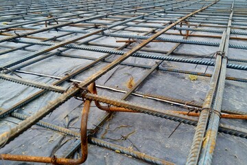 Preparation of the floor of an industrial building for pouring with concrete, installation of steel reinforcement.