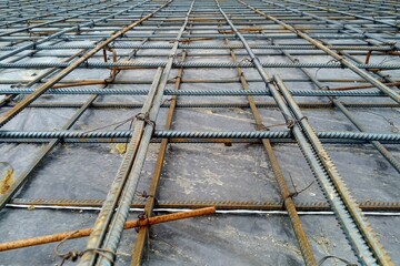 Preparation of the floor of an industrial building for pouring with concrete, installation of steel reinforcement.