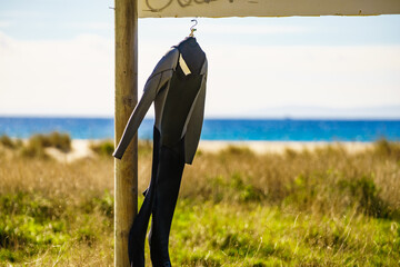 Diving suit drying on beach with sea view
