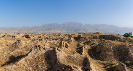 Fototapeta na wymiar Landscape panorama of the Zeravshan river valley with ruins of ancient silk road sogdian city Penjikent in foreground, Panjakent, Sughd region, Tajikistan
