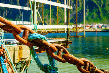 Rusty old metal chain links in port.