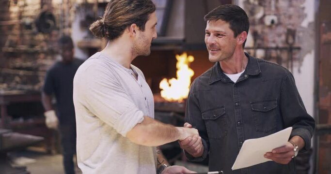Manufacturing worker handshake for contract agreement with tablet, paperwork or b2b partnership in workshop. Businessman and metal welding manager shaking hands for welcome, success or collaboration