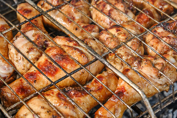 Meat on barbecue grill. Grilled chicken legs or drumsticks. Сooking on the grill. Shallow depth of field