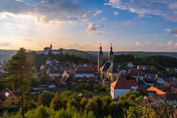 View of the pilgrimage basilica of Gößweinstein/Germany in Franconia at sunset with the castle in the background