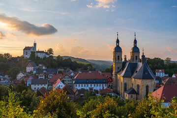 Fototapeta premium View of the pilgrimage basilica of Gößweinstein/Germany in Franconia at sunset with the castle in the background