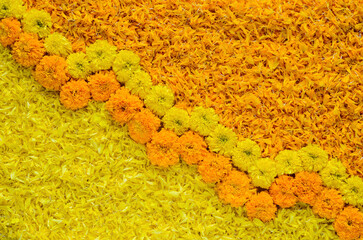 Decorative yellow and orange color marigold flowers and petals rangoli for Diwali festival.