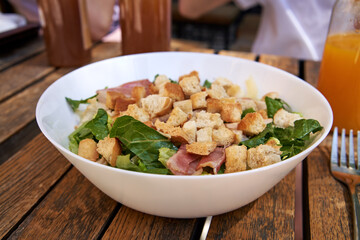 Caesar salad with croutons, lettuce and bacon