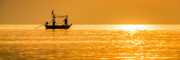 Silhouette Fishing boat with sunshine in the morning, Fishing in the Caribbean - Fishing boat