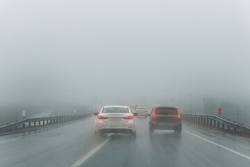 Car overtake rules violation crossing double lane. traffic on foggy misty rainy highway intercity...