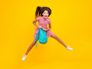 Fototapeta na wymiar Amazed teen girl. School teen girl in with backpack. Teenager student on isolated background. Kids learning, education, studying and knowledge. Run and jump. Excited expression, cheerful and glad.