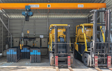 Forklifts parked to charge batteries © Ratchapon