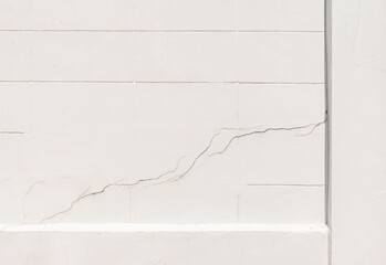 Texture white concrete wall has cracks
