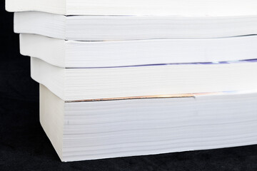A pile of books on a white background with shallow depth of field
