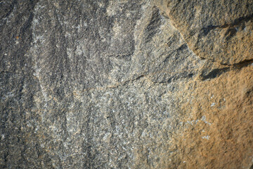 Background texture of old chipped natural stone close-up
