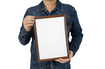 A blank diploma or a mockup certificate is in the hand of a male employee wearing a denim shirt on the cut-out. The picture frame is empty and the copy space. selective focus.