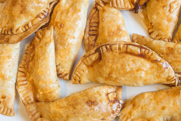 Overhead view of delicious baked toasted wafers stuffed with tuna and egg on a white plate.